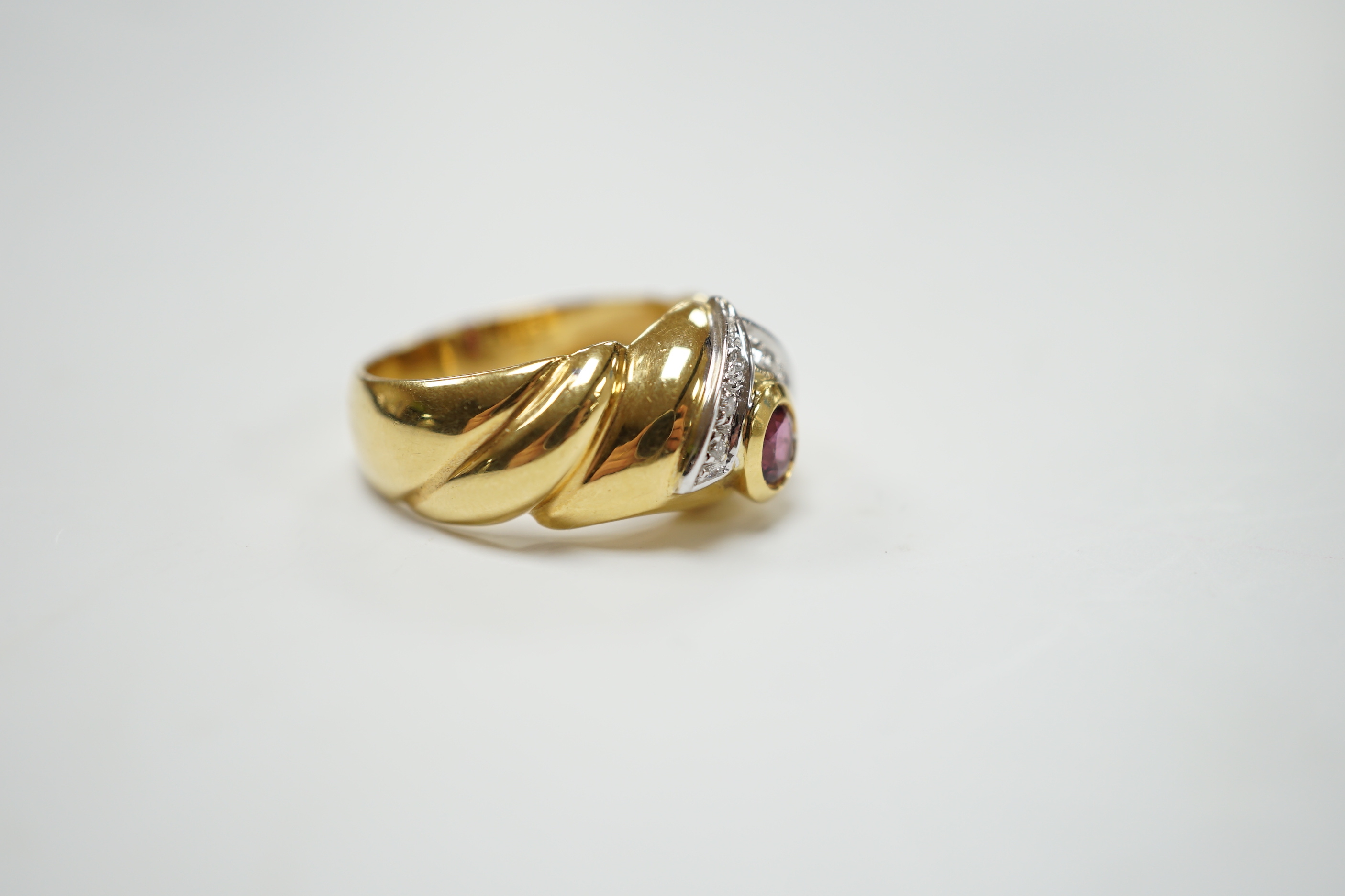 A modern 18ct gold, single stone deep pink sapphire and six stone diamond chip cluster set dress ring, size P, gross weight 8.3 grams.